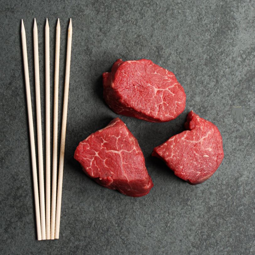 overhead of premium beef tenderloin brochettes with 10 x 3 oz pieces and 5 skewers.