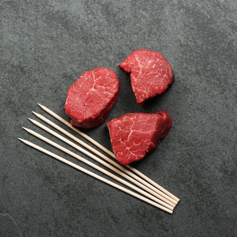 overhead of premium beef tenderloin brochettes with 10 x 3 oz pieces and 5 skewers.