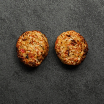 Overhead image of two cooked Seafood & Crab Cakes on a slate.