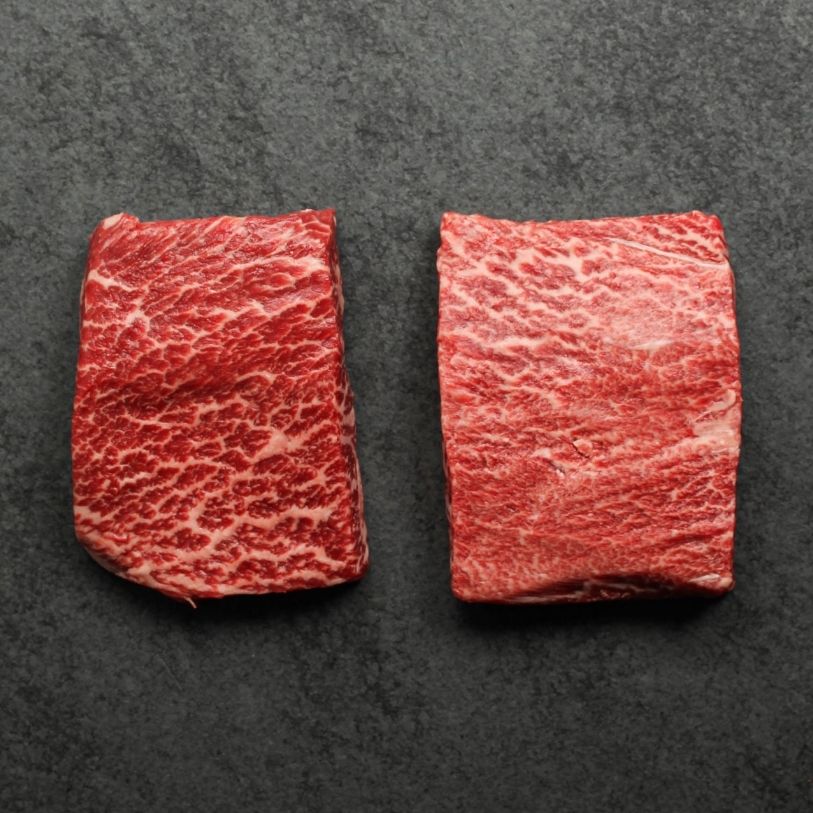 overhead view of two, heavily marbled wagyu flat iron steaks