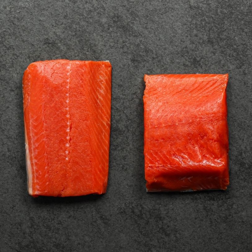 overhead view of two raw, vibrant wild sockeye salmon portions