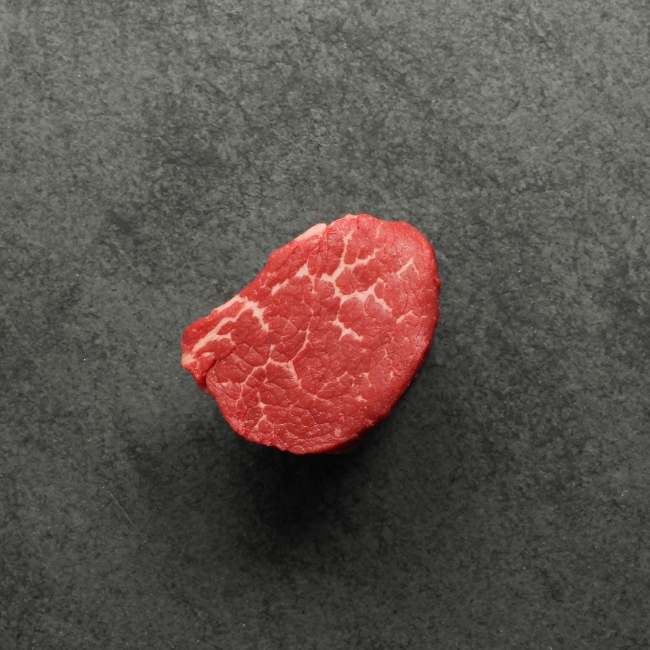 overhead view of a raw, Canadian Prime 4 oz filet mignon steak
