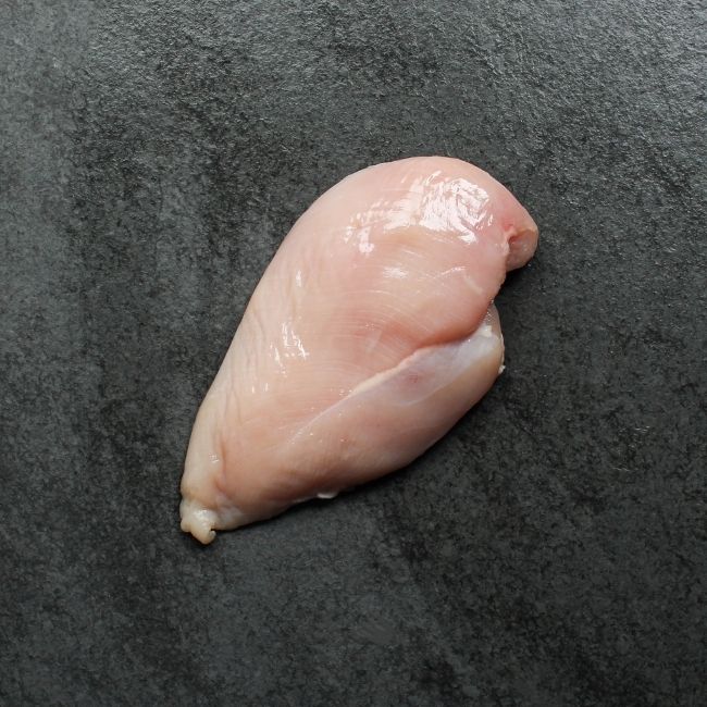 Overhead view of one, raw boneless skinless chicken breast