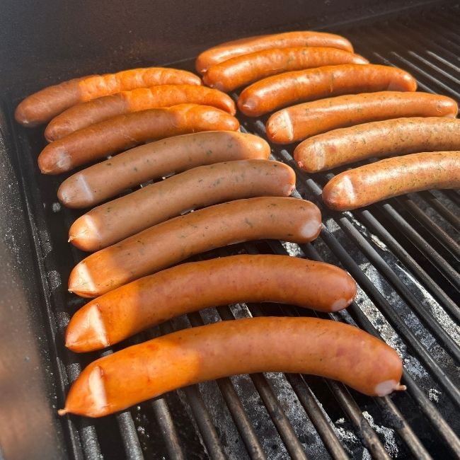 cooked debreziner sausages on a bbq