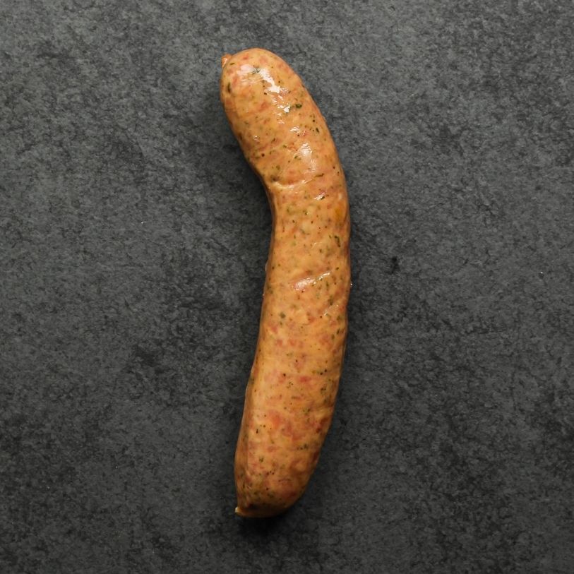 overhead shot of a raw mild Italian chicken sausage on black slate