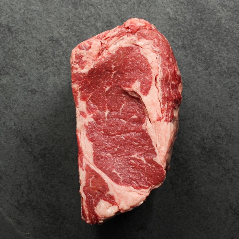overhead view of the side of a raw boneless ribeye roast