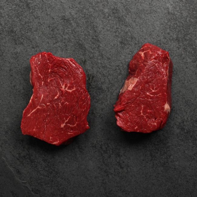 overhead view of the underside of two raw Australian wagyu beef sirloin steaks