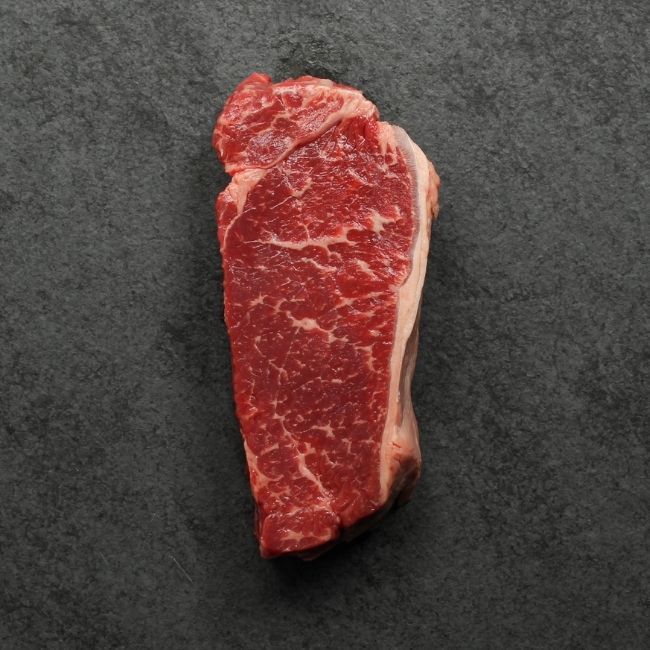 overhead view of a raw grass fed new york steak
