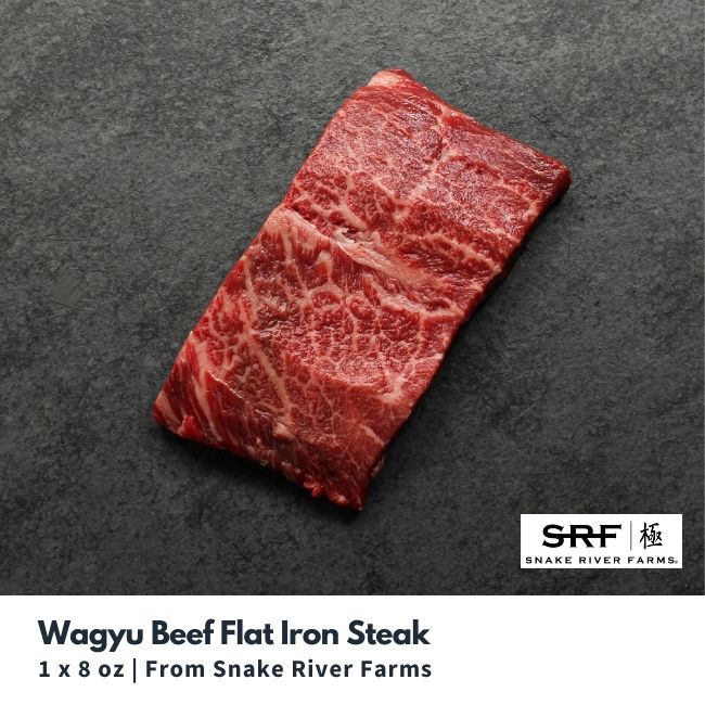 Overhead view of a raw, heavily marbled wagyu beef flat iron steak