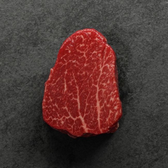 overhead view of a raw heavily marbled American-wagyu beef hybrid filet mignon