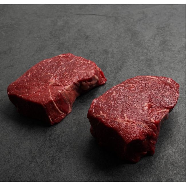 angled view of two raw Australian wagyu beef sirloin steaks