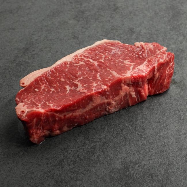 overhead view of a raw grass fed new york steak