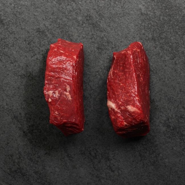 overhead view of the sides of two raw Australian wagyu beef sirloin steaks