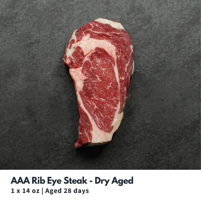 Overhead view of a raw, heavily marbled, dry aged rib eye steak