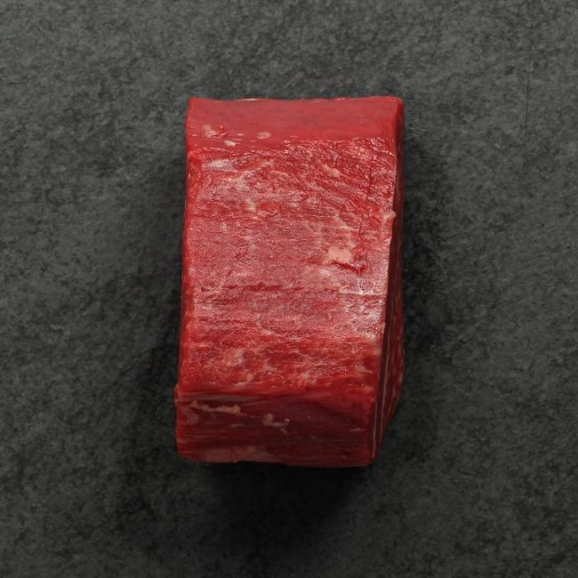 side view of a raw heavily marbled American-wagyu beef hybrid filet mignon
