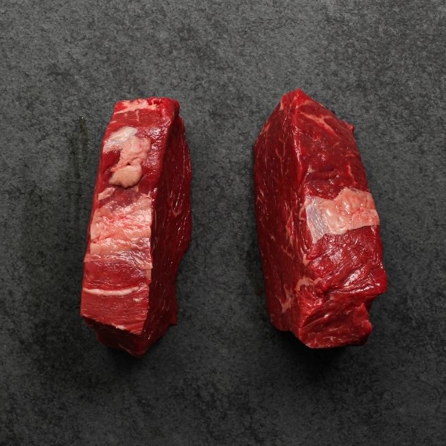 overhead view of the sides of two raw Australian wagyu beef sirloin steaks
