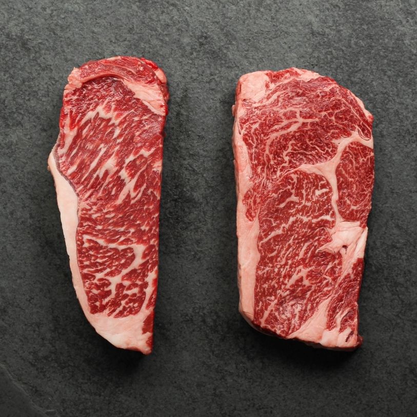 overhead view of a raw New York steak and ribeye steak
